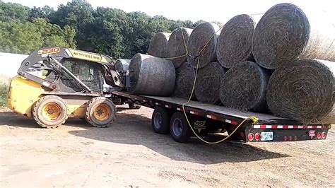 carry bales of hay with 1845c skid steer|round bales skid steer.